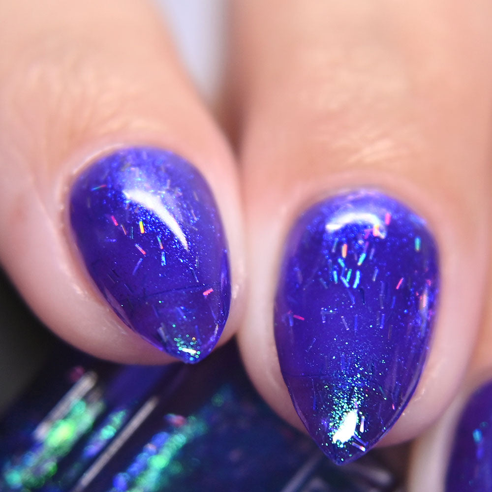 Close-up of nails with purple glitter nail polish by Kathleen & Co