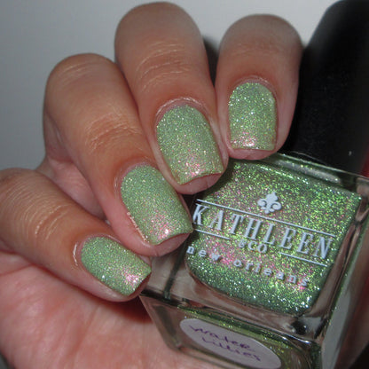 Green reflective glitter  nail polish with a visible brand name on the bottle.
