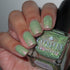 Green reflective glitter  nail polish with a visible brand name on the bottle.