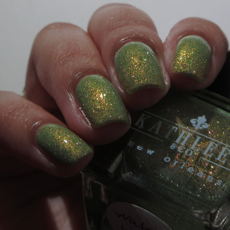 Green reflective glitter  nail polish with a visible brand name on the bottle.