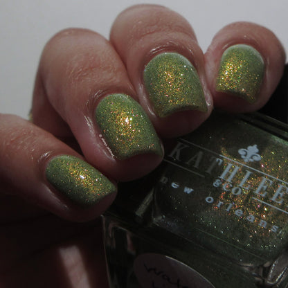 Green reflective glitter  nail polish with a visible brand name on the bottle.