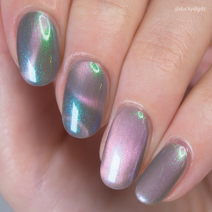 Close-up of a hand with magnetic nail polish on a neutral background