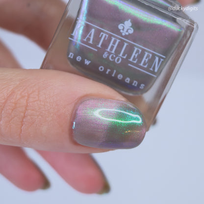 Nail polish with a magnetic effect held by a hand, with &