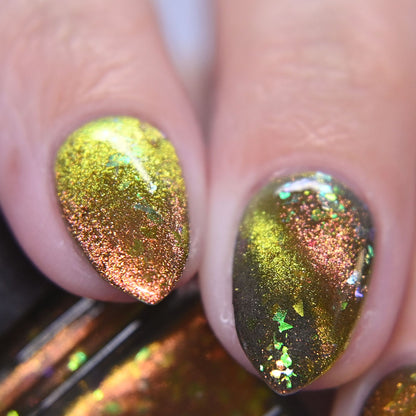 Close-up of nails with green and gold magnetic nail polish.