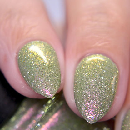 Close-up of nails with green reflective glitter nail polish