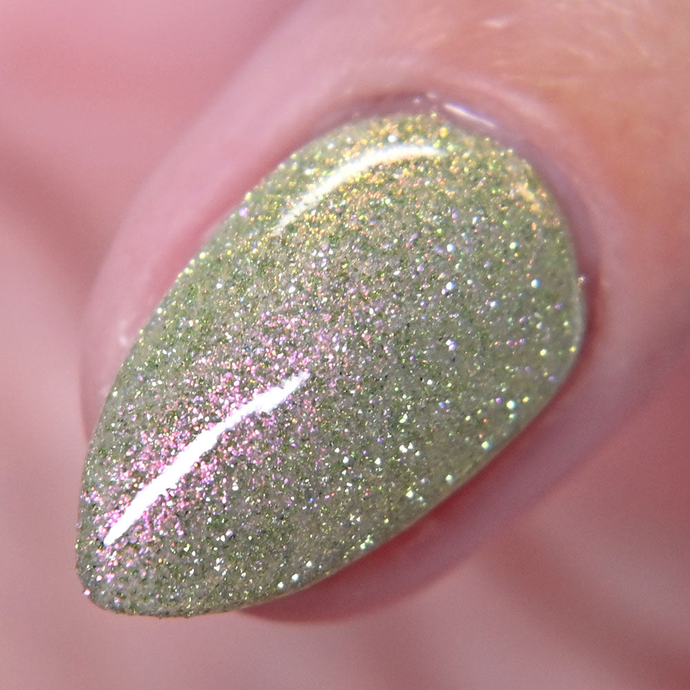 Close-up of a green reflective glitter nail polish on a finger