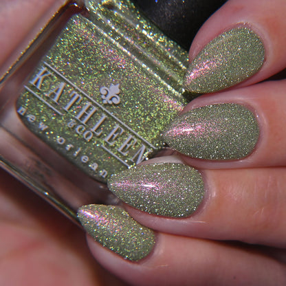 Nail polish with green reflective color with pink shimmer and &