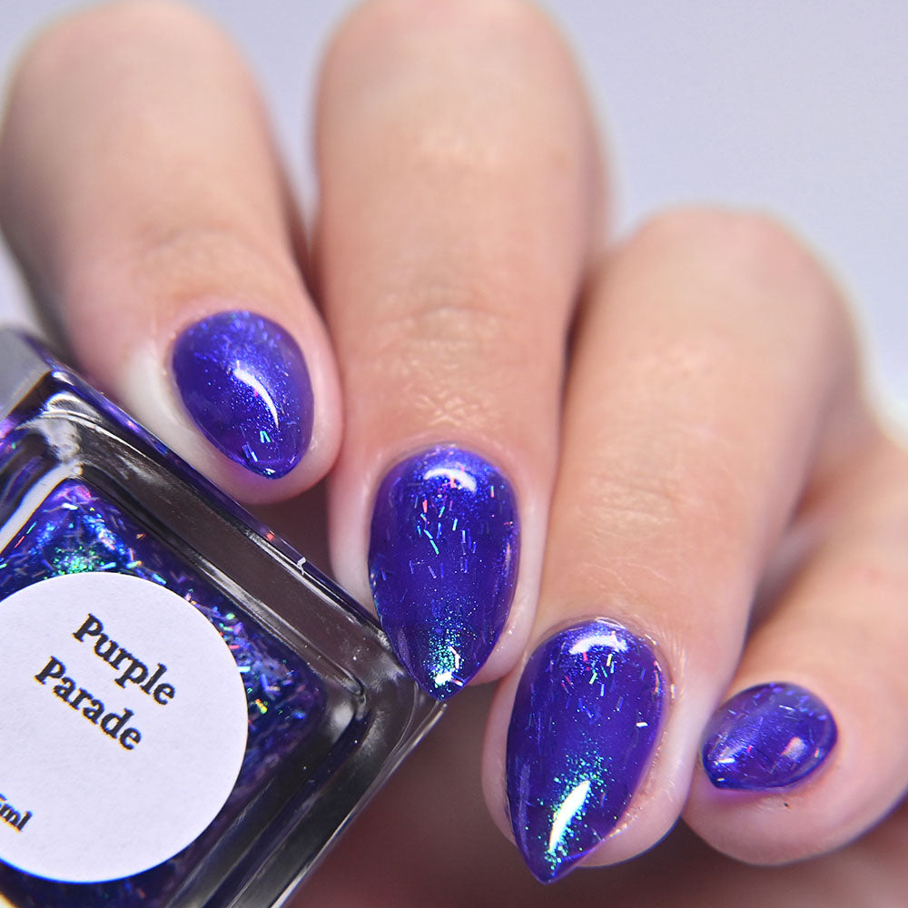 Nails with purple nail polish matching a bottle labeled &