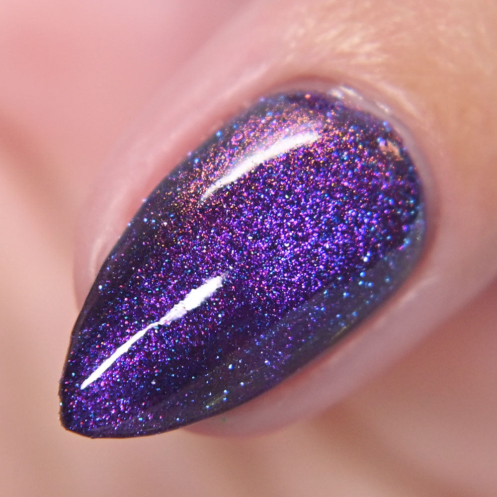 Close-up of a purple glittery nail polish on a neutral background