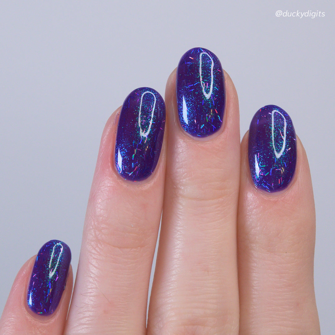 Kathleen &amp; Co Purple Glitter polish on swatcher hand