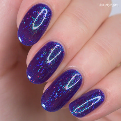 Close-up of a hand with kathleen &amp; co purple nail polish and glitter, branded &