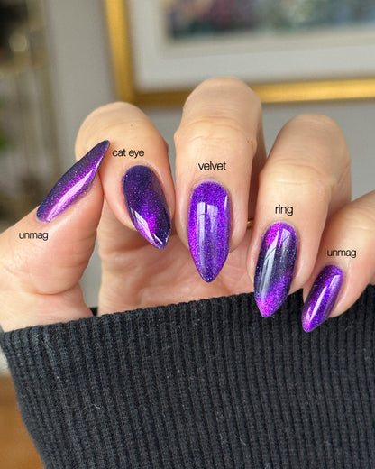 Close-up of a hand with purple glittery nails labeled with different magnetic nail styles.