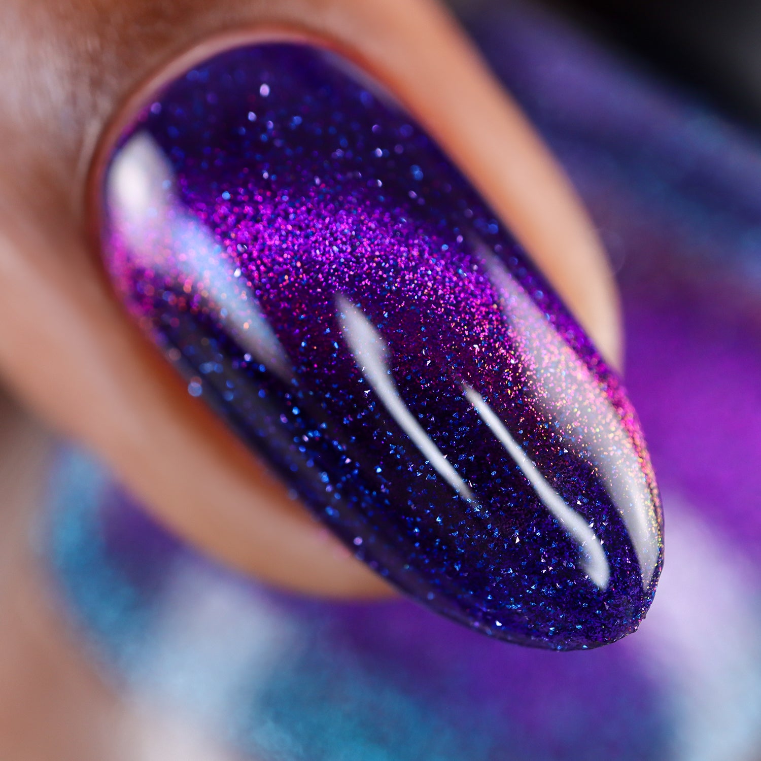 Close-up of a nail with purple  magnetic glitter polish
